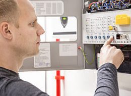 IT engineer or technician looking at alarm panel for aspirating fire detection system in datacenter. Inerte gass or nuvek gass system.